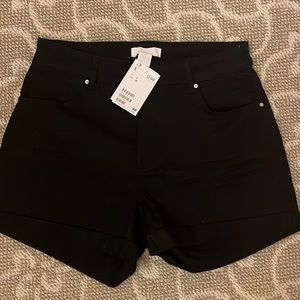 Black jean shorts  cuffed leg. Front and back pockets